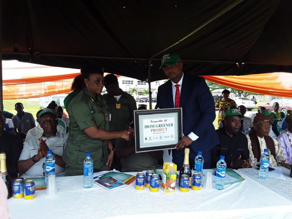 Prince Ikim receiving a certificate from Conservator Caroline Olori marking official Launch of Ibom Greener Project